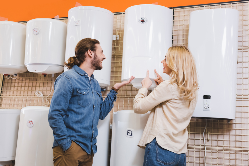 Couple evaluating tank and tankless models in a store to understand the types of water heaters.